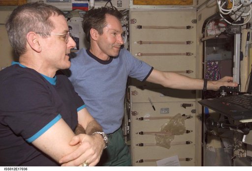 Tokarev and McArthur watch the RadioSkaf CD on a PC after opening the SM-RadioSkaf-11.1 Kit on Expedition 12