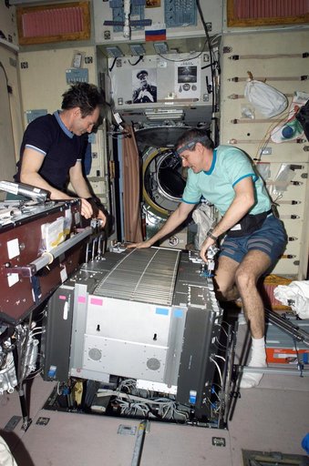 McArthur and Tokarev lift TVIS from the SM pit during TVIS inspection on Expedition 12