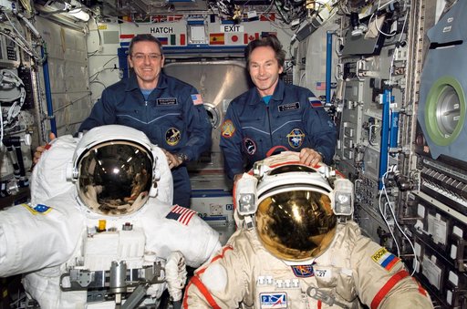 McArthur and Tokarev pose with EMUs during Expedition 12