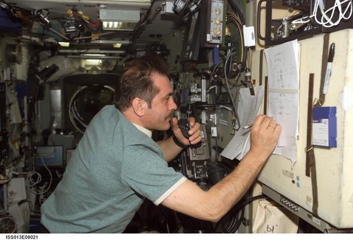Vinogradov writes down call signs of amateur radio operators in the SM during Expedition 13