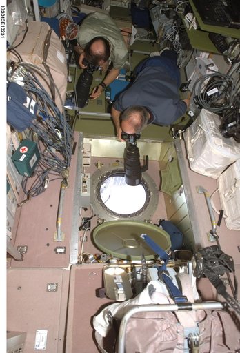 Williams and Vinogradov take pictures in the SM during Expedition 13