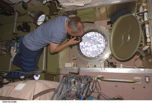 Williams takes pictures at the SM window during Expedition 13