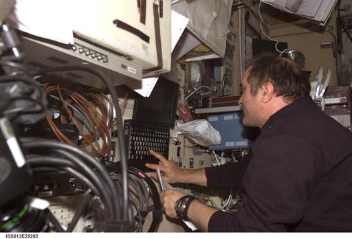 Vinogradov enters data into laptop computer in the SM during Expedition 13
