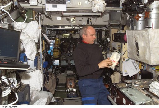 Williams holds package of food in the SM during Expedition 13