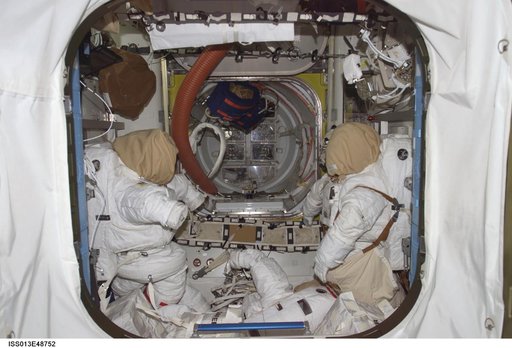 EMUs stowed in the Quest Airlock during Expedition 13 and STS-121 joint efforts