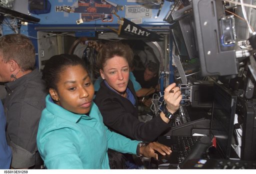 Nowak and Wilson work at a RWS during Expedition 13 / STS-121 joint operations