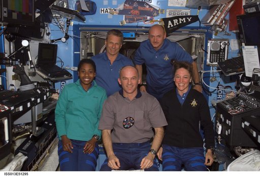 Expedition 13 and STS-121 crew members work in the U.S. Lab during joint operations