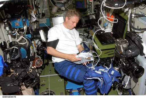 Reiter works with Heart Rate and Blood Pressure measuring devices in the SM during Expedition 13