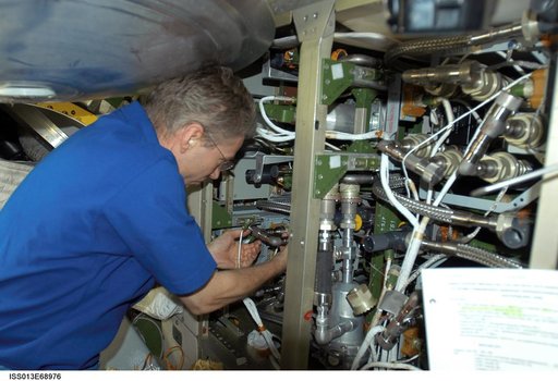 Reiter works on the Internal Thermal Cooling Loop Pump in the SM during Expedition 13