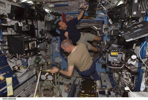 Lopez-Alegria and Williams installing the FSS in the U.S. Laboratory