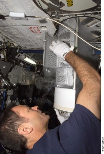 Lopez-Alegria with Passive Observatories for Experimental Microbial Systems in Micro-G (POEMS) sample container