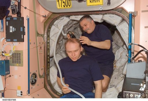 Yurchikhin gives Kotov a haircut in the Node 1 during Expedition 15