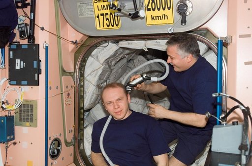 Yurchikhin gives Kotov a haircut in the Node 1 during Expedition 15