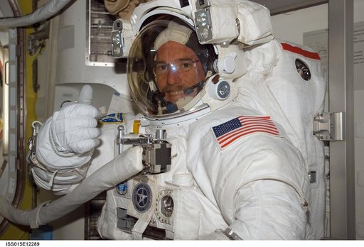 View of Reilly posing for a photo in the A/L during STS-117/Expedition 15 Joint Operations
