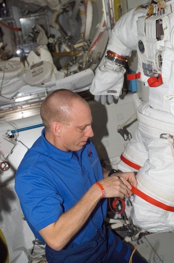View of Anderson working with an EMU in the A/L during Expedition 15
