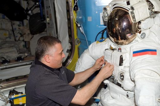 View of Yurchikhin working with an EMU in the A/L during Expedition 15