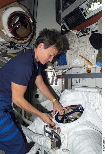 Expedition 16 CDR Whitson works with an EMU