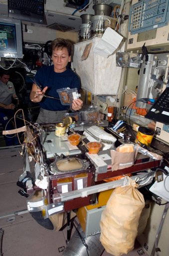 Whitson prepares a meal in the SM