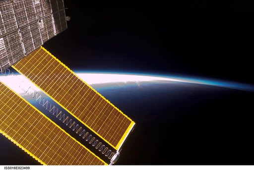 View of Solar Arrays through a Window on the ISS