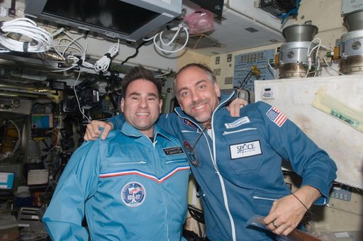 Chamitoff and Garriott pose for photo in the SM during Joint Operations