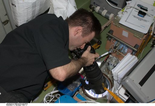 Chamitoff uses still camera in the SM during Joint Operations