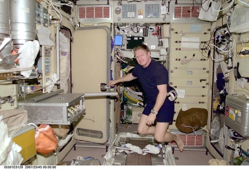 Shepherd in Service Module installing items