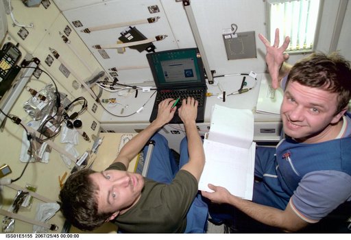 Krikalev and Gidzenko with laptops in Service Module