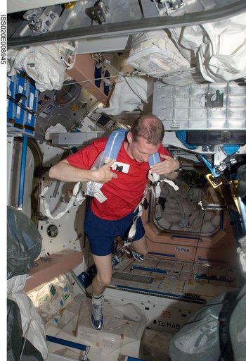 De Winne stows exercise equipment in the Node 1