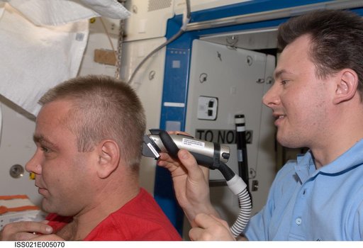 View of Expedition 21 Crew Members trimming hair in the Destiny Laboratory