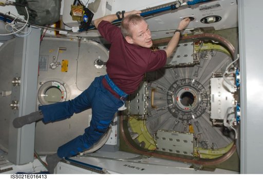 View of Commander De Winne floating near the Node 2 Nadir Hatch