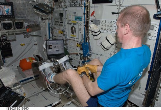 Commander De Winne exercises on the FWED in the Columbus Module