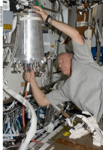 Expedition 21 FE Williams removes an EDV-U from the US WHC