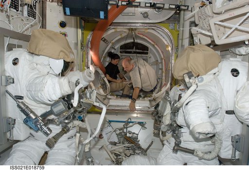 View of Expedition 21 Crew Members working in the Airlock