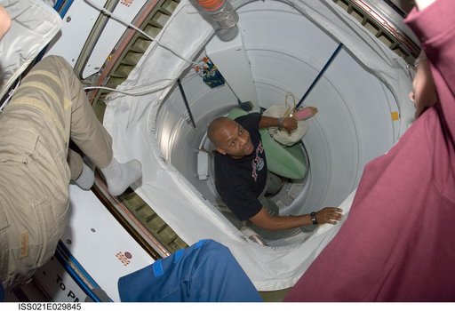 STS-129 Crew Member boards the ISS after docking