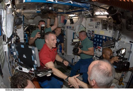 STS-129 and Expedition 21 Crew Members greet one another