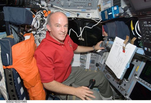 Expedition 21 FE Williams poses for a photo on the Atlantis Flight Deck