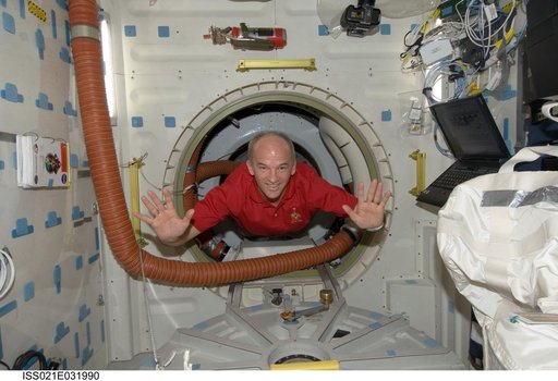 Expedition 21 FE Williams poses for a photo on the Atlantis Middeck