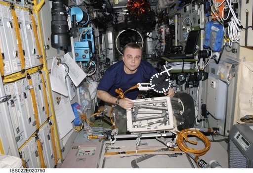 Creamer looks through EVA Equipment in the SM during Expedition 22