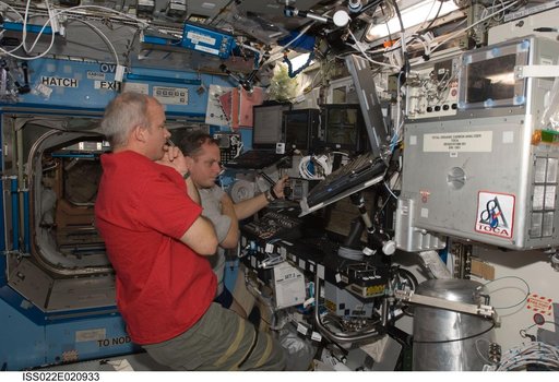 Williams and Creamer at SSRMS controls in the U.S. Laboratory during Expedition 22