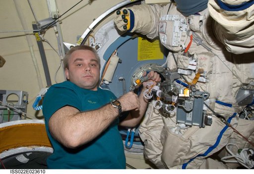 Suraev works on Orlan-MK Suit in the Pirs DC-1 during Expedition 22