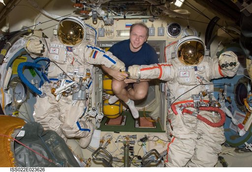 Kotov poses with Orlan-MK Suits in the Pirs DC-1 during Expedition 22