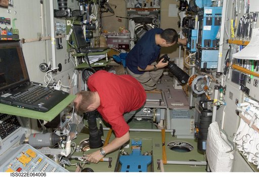 Kotov and Noguchi using camera equipment in the SM during Expedition 22