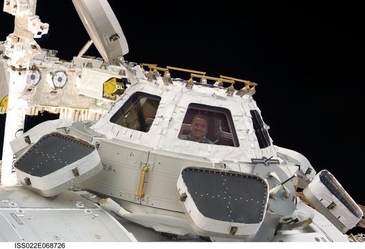 Zamka at window in the Cupola Module during Joint Operations