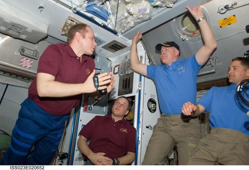 Crewmembers in Node 2 following Hatch Opening