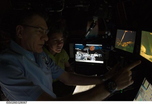 Coleman and Nespoli in the Cupola Module during Japanese Kounotori HTV-2 Transfer Vehicle Relocation