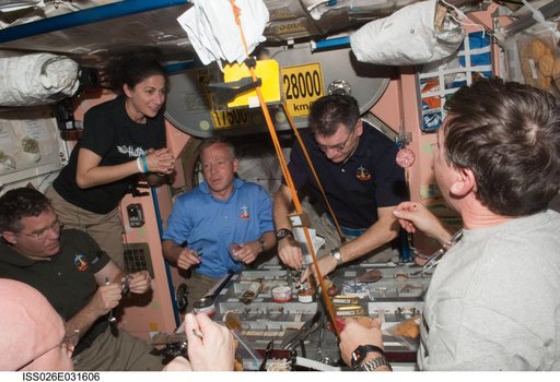 Expedition 26 and STS-133 Crewmembers enjoy meal in the Node 1