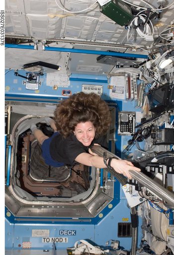 Coleman poses with the MCA VAJ in the US Lab