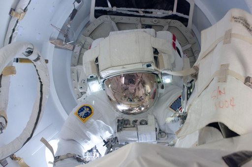 Chamitoff egresses Crew Lock at the start of EVA 1