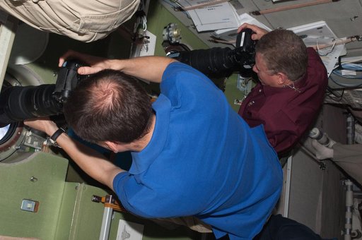 View of Expedition 28 Crew Members photographing the Shuttle Atlantis during Approach