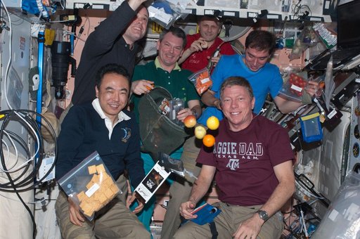 Expedition 28 crew members enjoy dinner in the Node 1